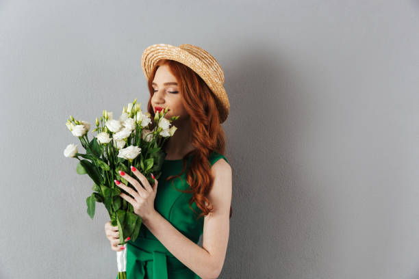 istock Cute redhead young woman holding flowers. 1300322547