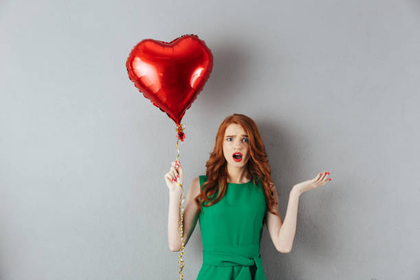 istock Confused redhead emotional young woman 1300322726