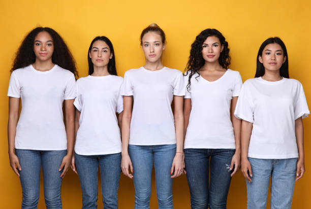 istock Five Serious Multiethnic Women Standing Together Over Yellow Background 1300324308