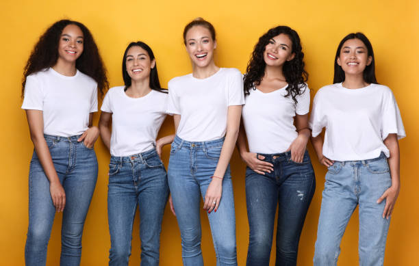 istock Five Positive Multiethnic Women Posing Standing Together, Yellow Background 1300324478