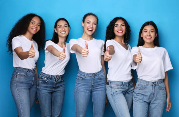 istock Group Of Cheerful Ladies Gesturing Thumbs-Up On Blue Studio Background 1300324640
