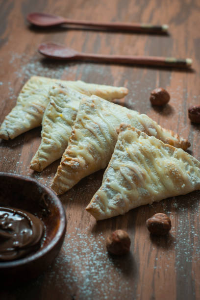istock Nutella hand pies and a bowl with nutella on a wooden table. 1300325673