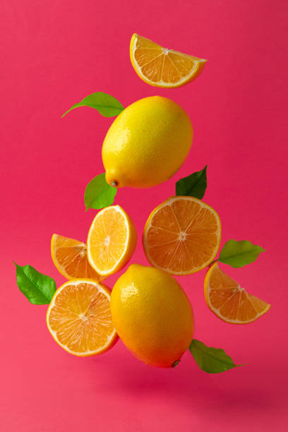 istock Lemons hovering in the air against bright pink background 1300326563