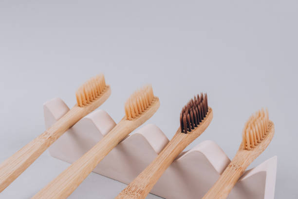 istock Natural bamboo toothbrushes on biege plaster mold against gray background with copy space. Sustainable lifestyle, zero waste home. Selective focus. Mockup image 1300326634