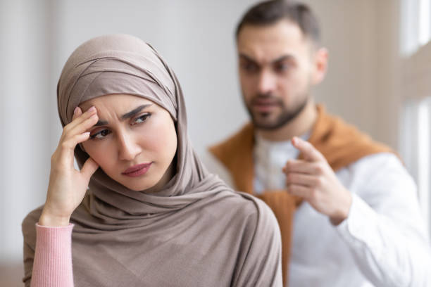 istock Husband Shouting At Depressed Wife Standing At Home 1300327515
