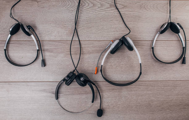 istock Four headsets on wooden background 1300328727