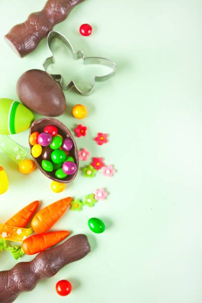 istock Easter set with eggs, carrots, chocolate bunny, cookie cutter. Top view. Copy space. 1300328813