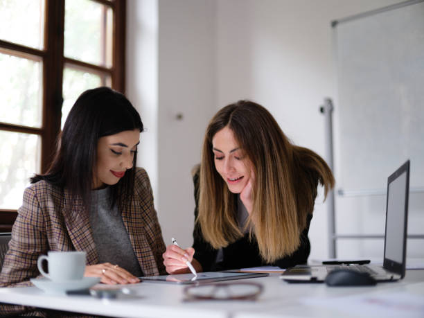 istock Businesswomen Discussing On Their New Project Using Laptop Computer And Digital Tablet In The Office 1300329957