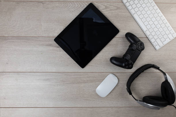 istock Video gaming setup on wooden background 1300330118