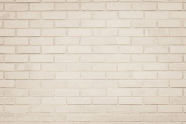 istock Empty Background of wide cream brick wall texture. Old brown brick wall concrete or stone pattern nature, wallpaper limestone abstract floor/Grid uneven interior rock. Home & office design backdrop. 1300331361