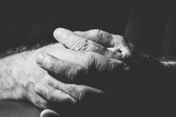 istock close-up of two folded hands in black and white 1300331446