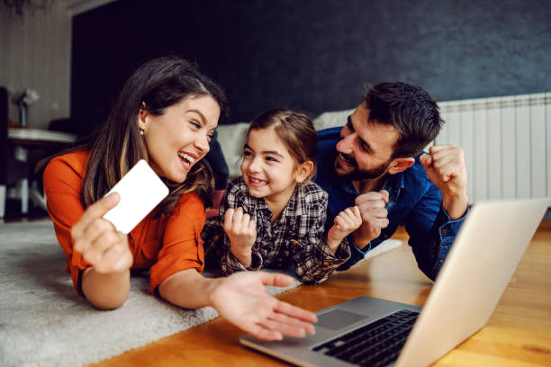 happy family using laptop for online shopping. they are excited for purchase. mom holding credit card. - laptop women child digital tablet imagens e fotografias de stock