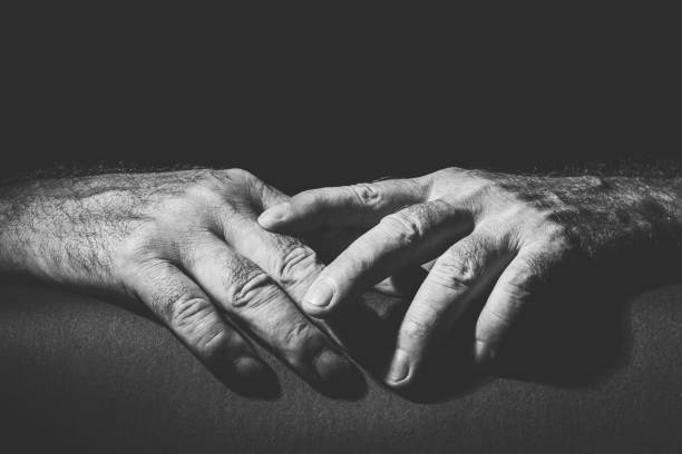istock two relaxed hands lying on top of each other 1300332897