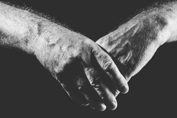 istock one hand covers the other hand, in black and white 1300333153