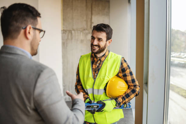 istock A construction worker standing with architect and discussing about building. Building in construction process interior. 1300333517