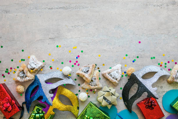 istock Purim celebration concept (jewish carnival holiday) on white background, top view, copy space. flat lay with hamantaschen cookies and purim mask. 1300333551
