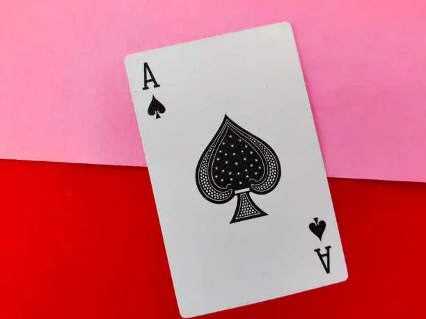 Ace of big spade symbol playing card isolated on pink and red background