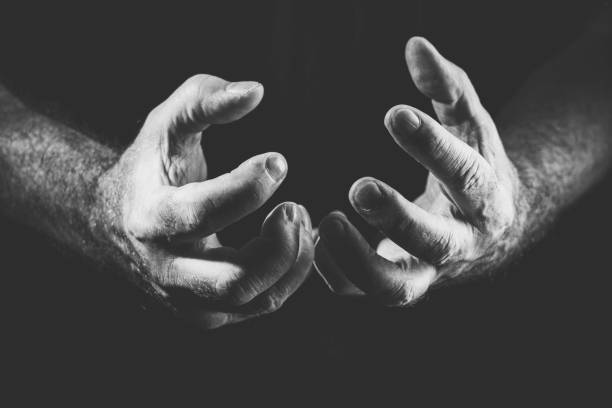 istock two desperate hands, in black and white 1300334405