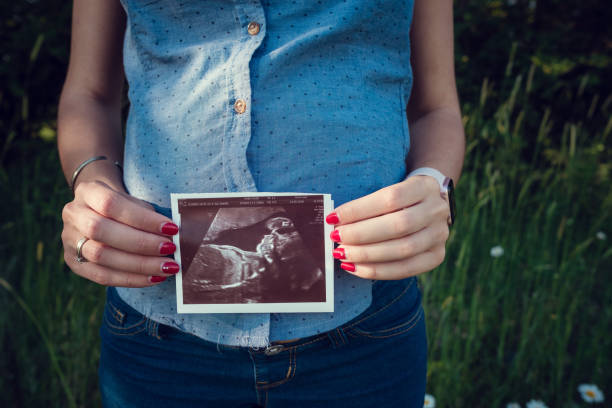istock pregnant mom expecting in the summer field 1300334917