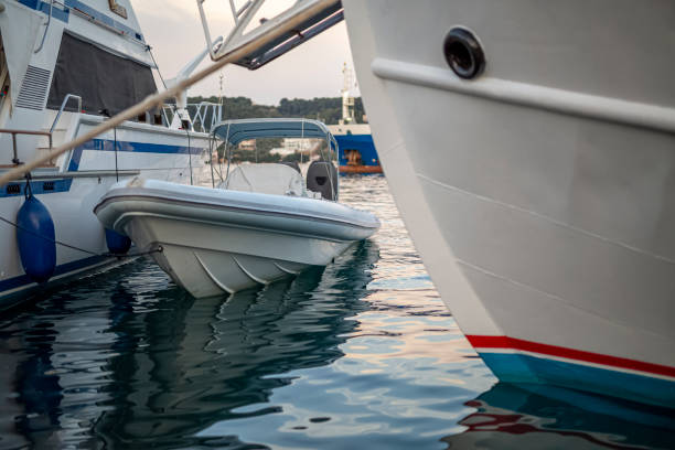 istock Small motorboat at the dock with beautiful reflections in the water. 1300335230