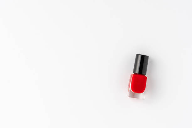 istock Red nail polish isolated on white background with copyspace. Top view 1300336093