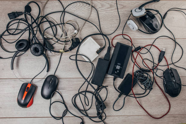 istock Messy computer equipment on wooden background 1300336395