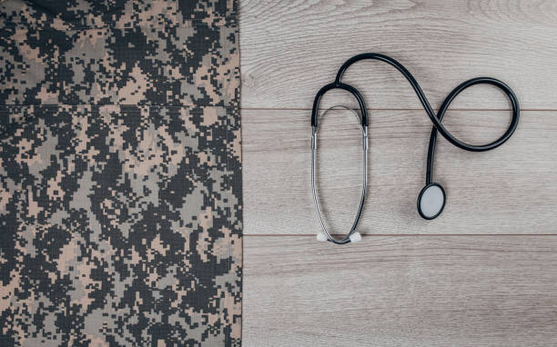 istock Stethoscope next to army camouflage uniform on wooden background 1300337596