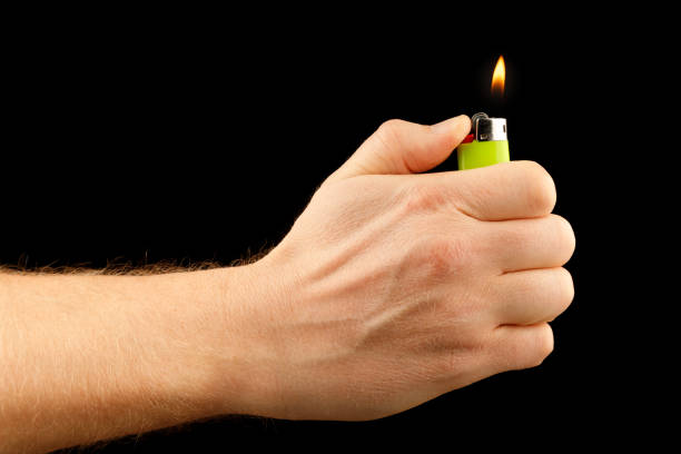 lighter in hand on a black background - fire match women flame imagens e fotografias de stock