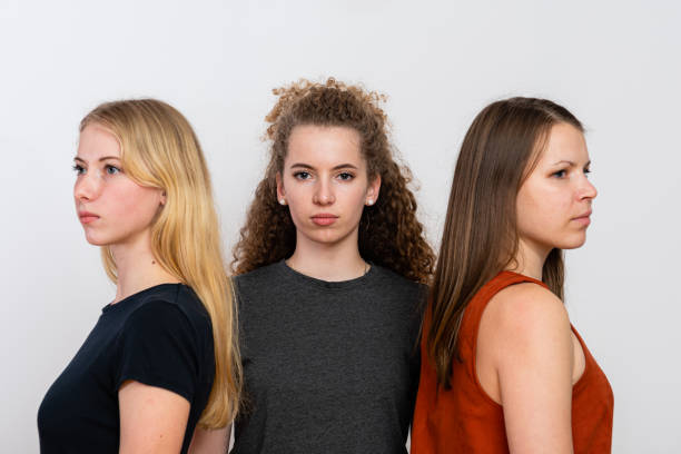 istock three women standing against each other, group portrait, isolated on a white background 1300339756