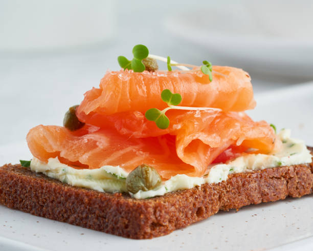 istock Smorrebrod - traditional Danish sandwiches. Black rye bread with salmon 1300339943