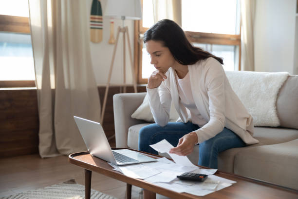 istock Anxious young woman comparing paper and online document information 1300340926