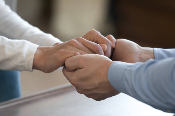 istock Young loving couple holding hands supporting comforting in difficult time 1300340946