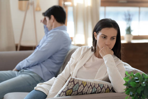 istock Nervous young couple sitting on sofa keeping silence after argument 1300340951