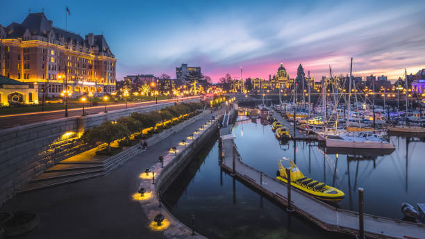 Victoria Inner Harbour During the Holidays Sunset cityscape panoramic view of the Inner Harbour, the Fairmont Empress Hotel and the Legislative Assembly of British Columbia in Victoria, B.C, Canada during Christmas Holidays. victoria canada stock pictures, royalty-free photos & images
