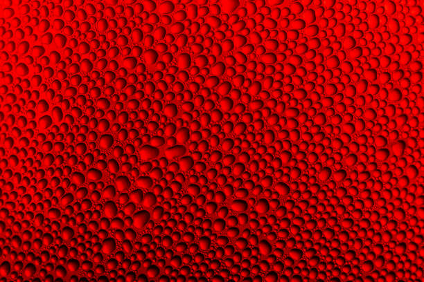 Water Drops background on the red glossy surface, Rain droplets on red texture. Natural fresh background.