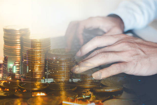 istock businessman working typing on keyboard with double exposure of coin stacking background for technology digital online financial concept online trading and cryptocurrency investment. 1300344523