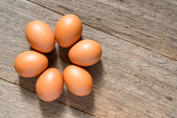 istock Chicken eggs on the wooden board background with a copy space. Flat lay. 1300345173