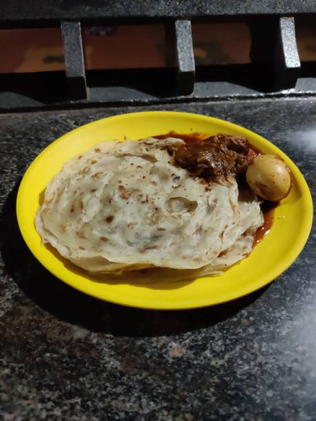 istock Parotta with curry in a plate closeup view 1300345417
