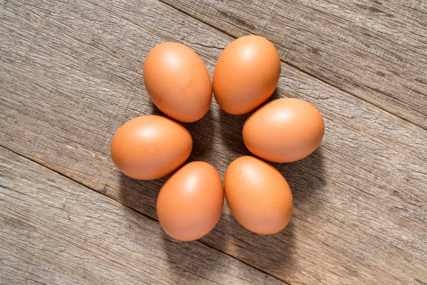 istock Chicken egg on the wooden board background. Flat lay. 1300345488