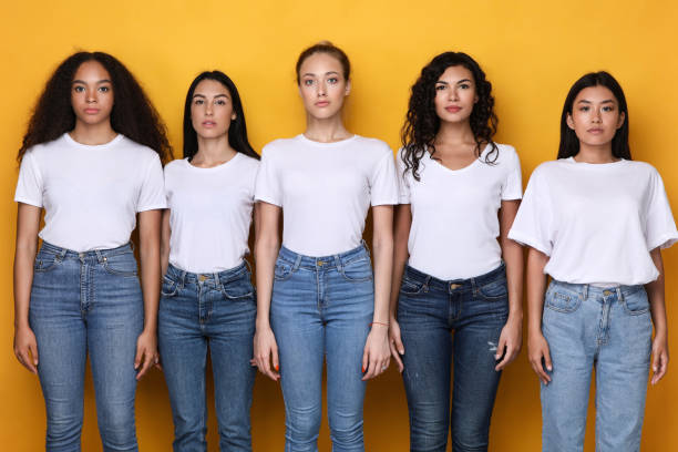 istock Group Of Five Serious Multiracial Ladies Standing Over Yellow Background 1300346840
