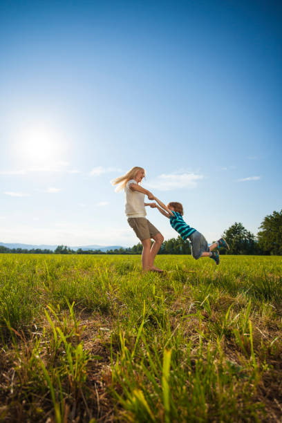 istock Spinning her boy on a summer day 1300347255