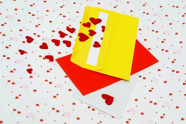 Red little hearts coming out from envelope on valentine day background with copy space, loveletter concept, close-up