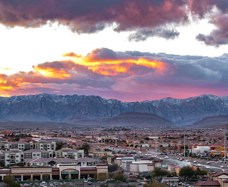 Suburb Residential area of Las Vegas at sunset with winter snow on top of Red Rock Canyon