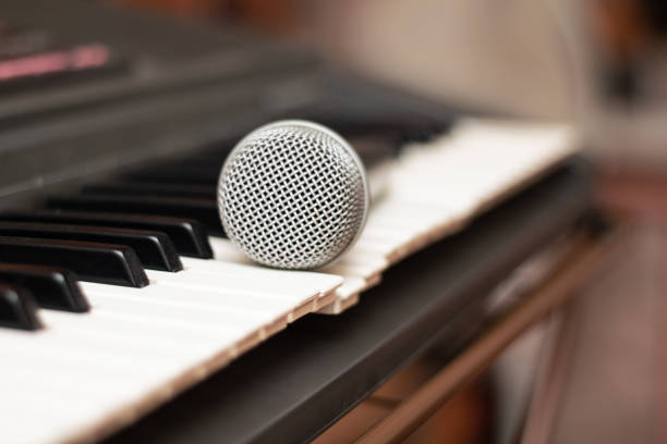 istock Microphone lies on the piano keys close up 1300349937