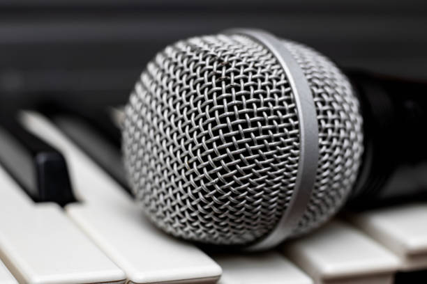 istock Microphone lies on the piano keys close up 1300349949