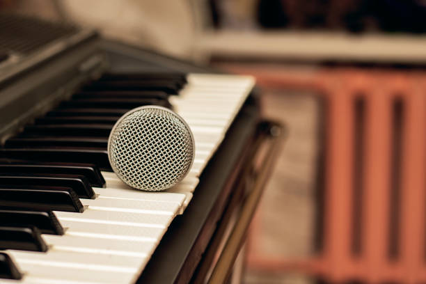istock Microphone lies on the piano keys close up 1300349954