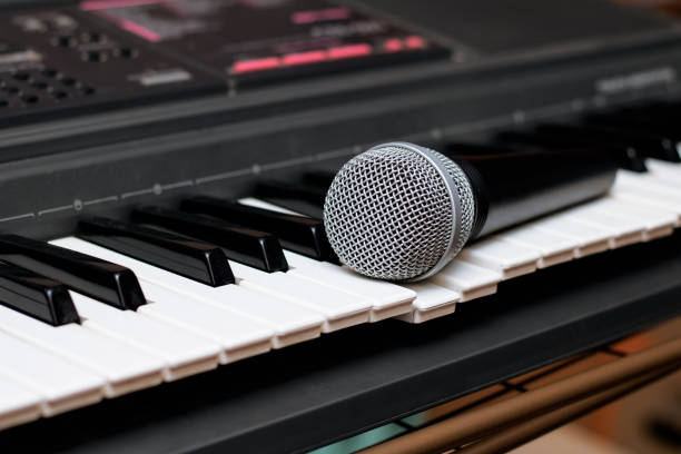 istock Microphone lies on the piano keys close up 1300349981