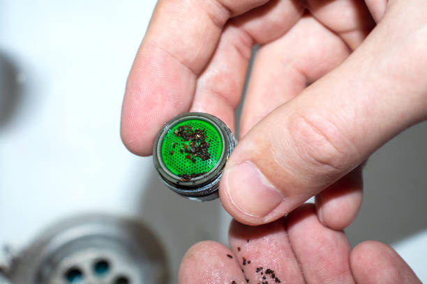 Plumber repairing the faucet of a sink. Plumbing repair concept. Cleaning the aerator on the mixer. Plumber repairing the faucet of a sink. Plumbing repair concept. Cleaning the aerator on the mixer water sanitation worker washing faucet stock pictures, royalty-free photos & images