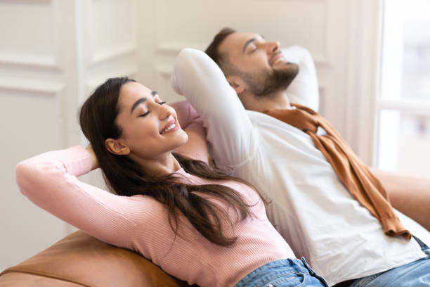 istock Happy Young Couple Relaxing Sitting On Sofa At Home 1300351224