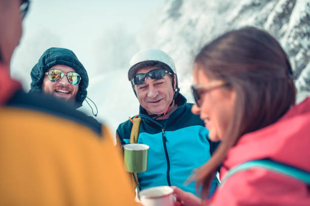 istock Alpinists Enjoying Tea Time On Mountain Top 1300353729